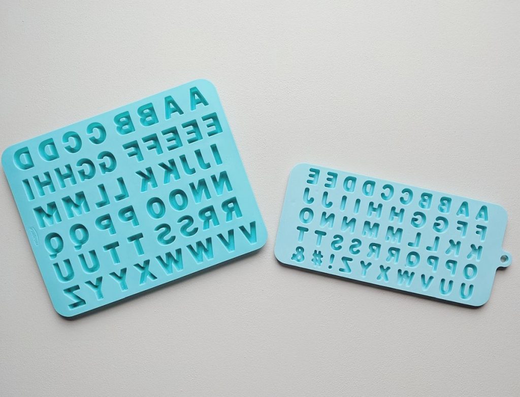 A turquoise alphabet mold for making candy.